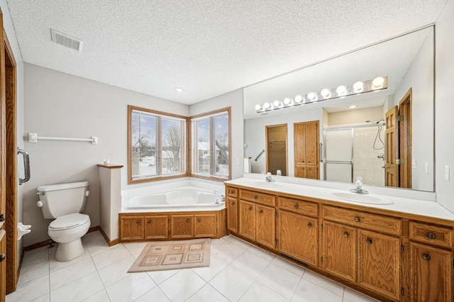 full bathroom with vanity, plus walk in shower, tile patterned flooring, toilet, and a textured ceiling