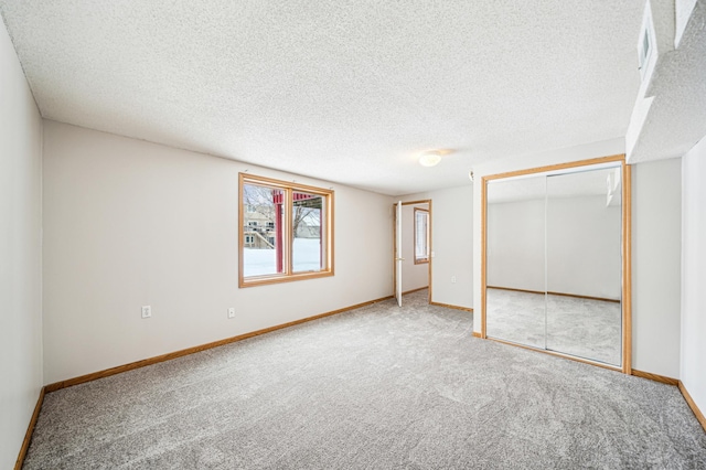 unfurnished bedroom featuring a closet, carpet, and a textured ceiling