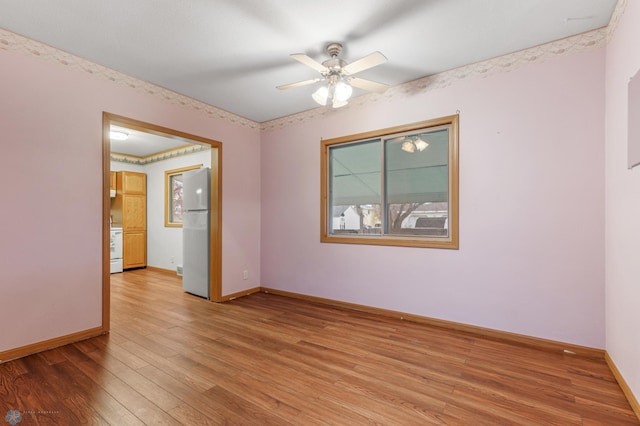 unfurnished room featuring ceiling fan and hardwood / wood-style floors