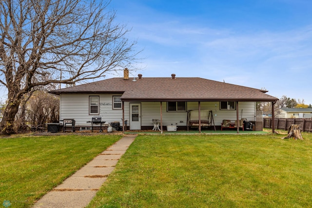 back of house featuring a yard