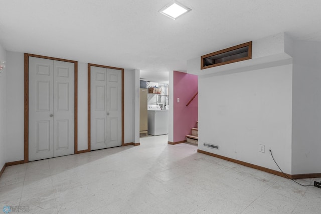 interior space featuring washer / clothes dryer and multiple closets