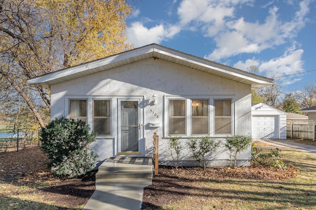 bungalow with an outbuilding and a garage