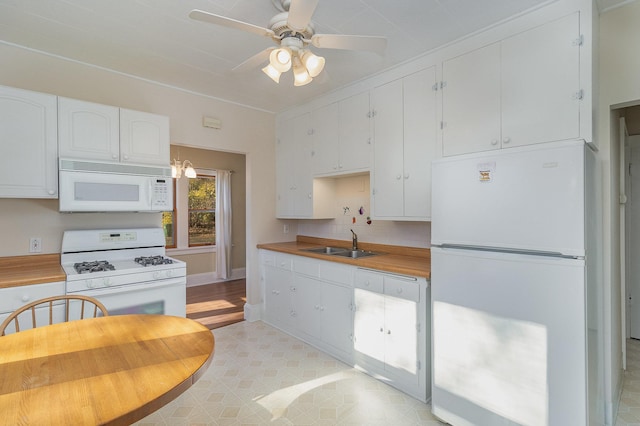 kitchen with white cabinetry, sink, ceiling fan, hanging light fixtures, and white appliances