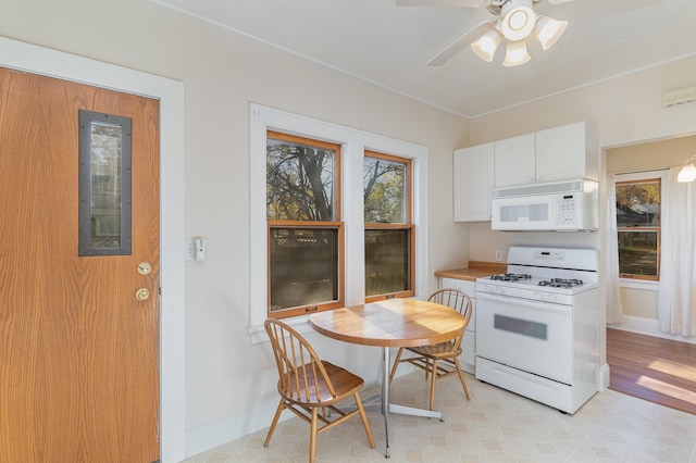 kitchen featuring white cabinets, ceiling fan, and white appliances