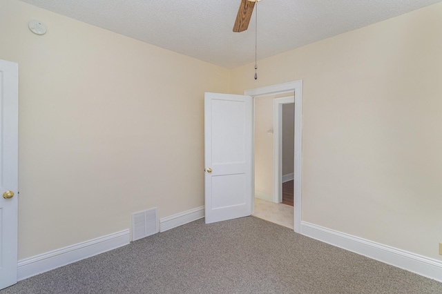 empty room featuring light colored carpet and a textured ceiling