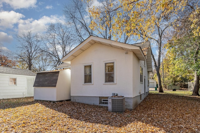 view of home's exterior featuring a storage unit and cooling unit