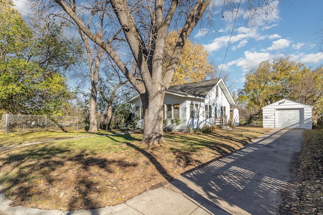 view of front of property with a garage, an outbuilding, and a front lawn