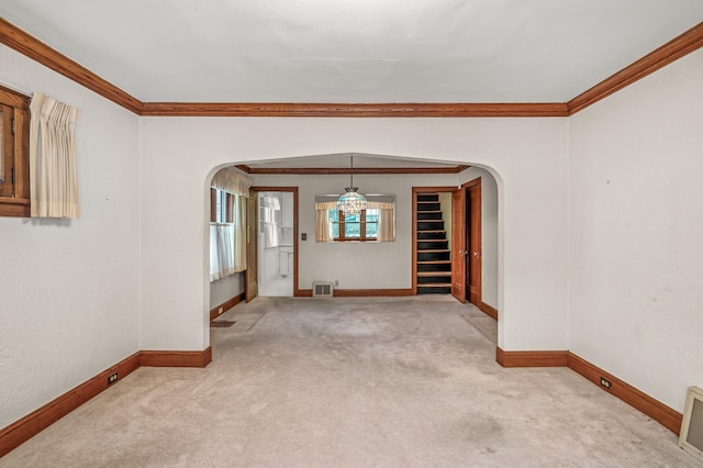 empty room with light colored carpet and ornamental molding