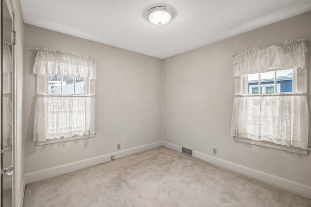 carpeted spare room with a wealth of natural light