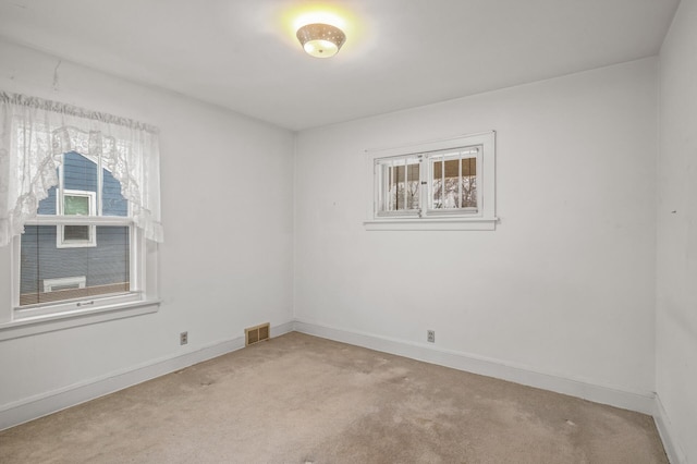 empty room featuring light colored carpet