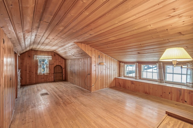 bonus room with wood walls, light hardwood / wood-style flooring, wood ceiling, and vaulted ceiling