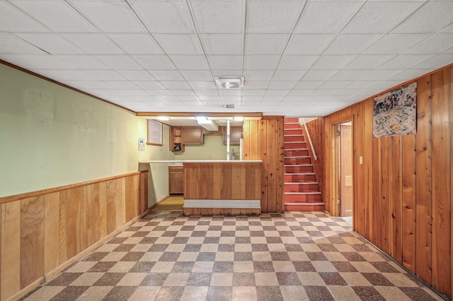 bar with crown molding and wooden walls