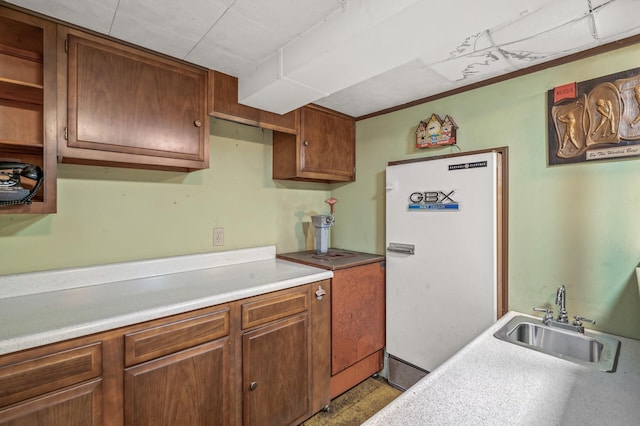 kitchen featuring white refrigerator and sink