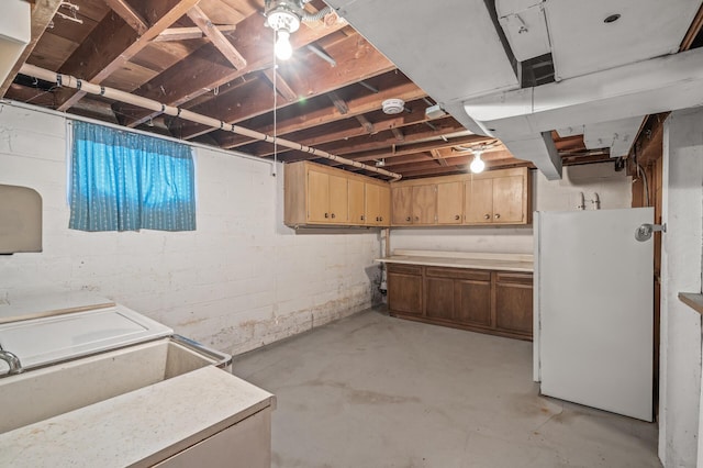 basement with white refrigerator