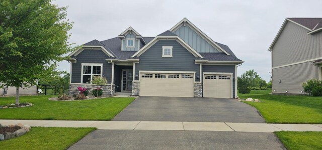 821 June Ave N, Lake Elmo, MN 55042 - craftsman inspired home with board and batten siding, driveway, a front yard, and stone siding