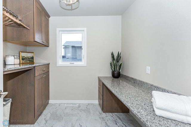 kitchen featuring light stone countertops