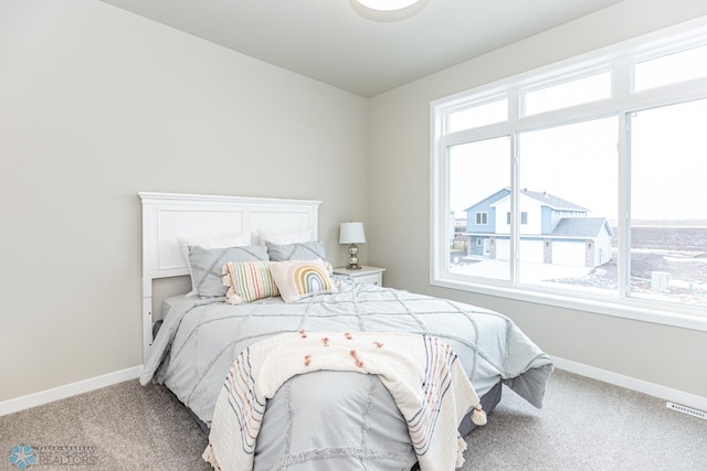 bedroom featuring carpet flooring and multiple windows