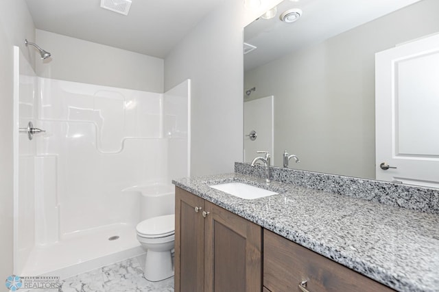 bathroom featuring vanity, toilet, and walk in shower