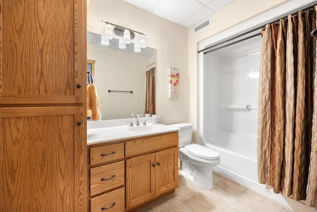 full bathroom with a paneled ceiling, vanity, toilet, and shower / bath combo with shower curtain