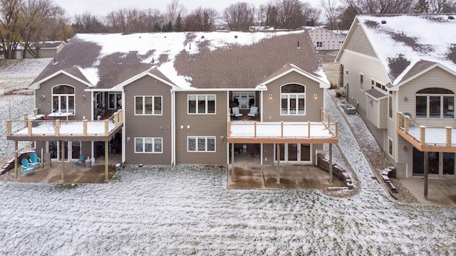 snow covered property featuring a patio