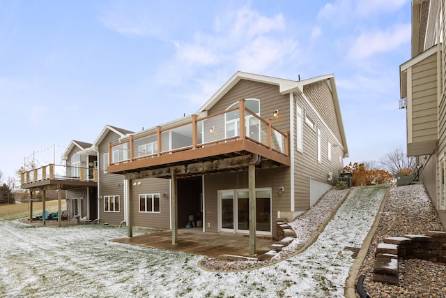 rear view of house with a patio area and a wooden deck