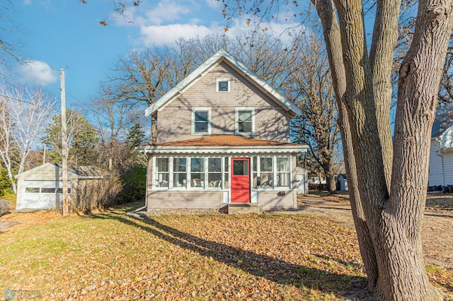 view of front of house featuring a sunroom and a front lawn