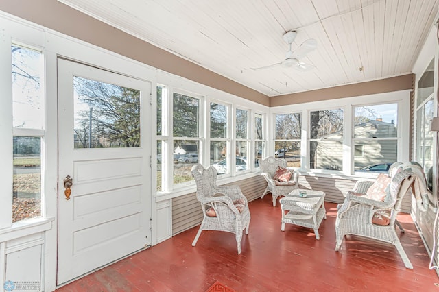 sunroom with plenty of natural light, ceiling fan, and wooden ceiling