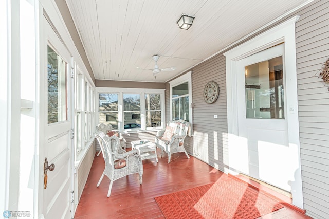 sunroom / solarium featuring ceiling fan and wooden ceiling