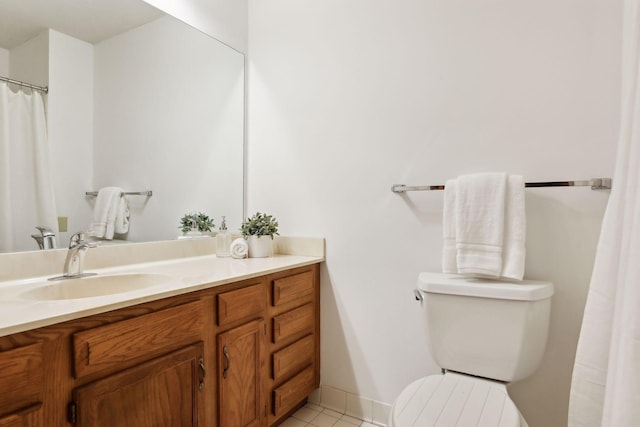 bathroom with tile patterned flooring, vanity, and toilet