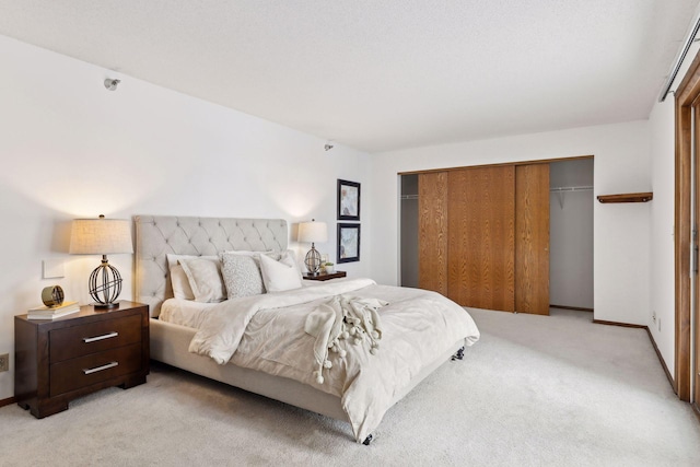 bedroom with light carpet and a closet