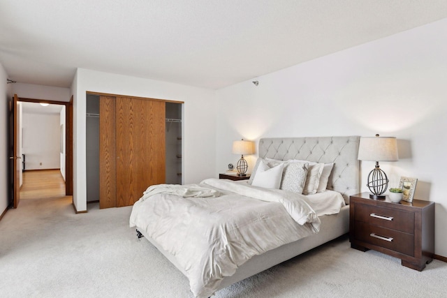 bedroom with light carpet and a closet