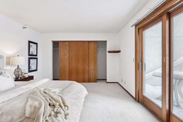 carpeted bedroom with access to exterior and a closet