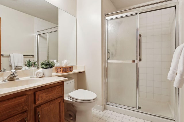 bathroom featuring toilet, vanity, tile patterned floors, and walk in shower