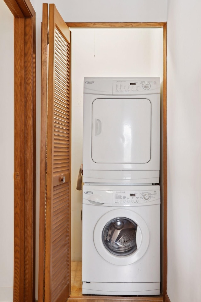 laundry area featuring stacked washer / drying machine