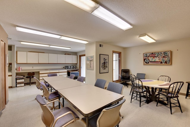 dining space with a textured ceiling