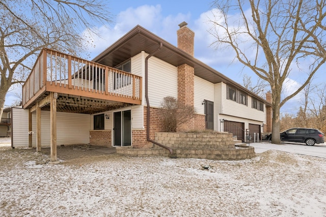 exterior space with a garage and a wooden deck