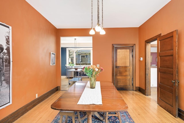 dining area featuring a notable chandelier and light hardwood / wood-style flooring