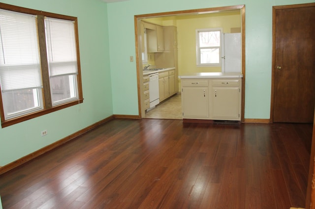 kitchen featuring hardwood / wood-style floors, white appliances, and sink