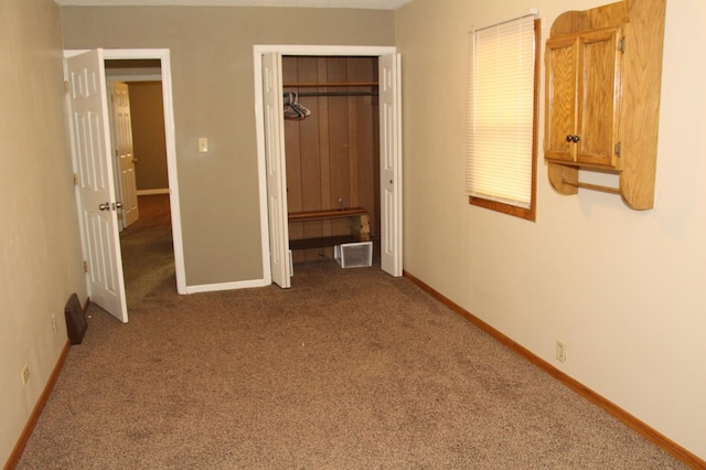 unfurnished bedroom with carpet floors and a closet