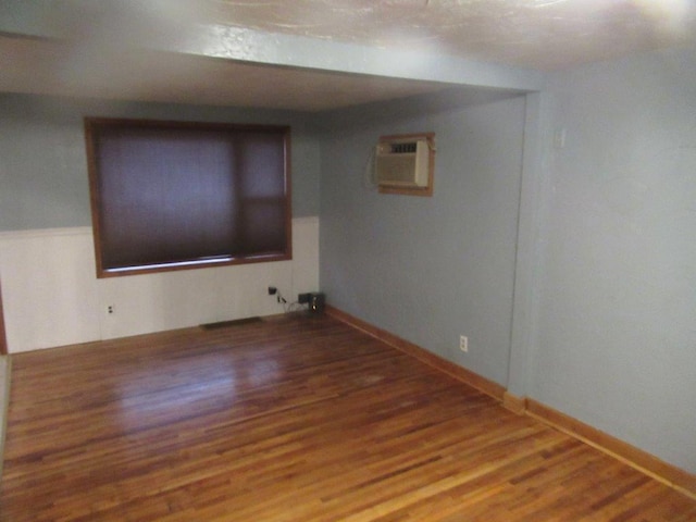 unfurnished room with wood-type flooring