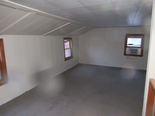 additional living space featuring vaulted ceiling and cooling unit