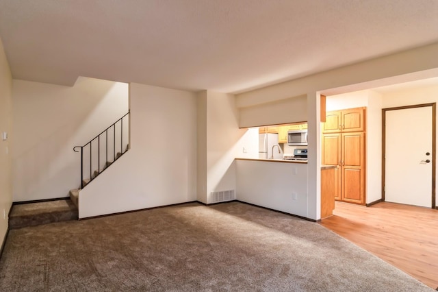 unfurnished living room with light hardwood / wood-style floors