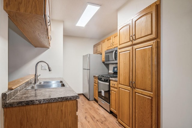 kitchen featuring sink, light hardwood / wood-style flooring, and appliances with stainless steel finishes