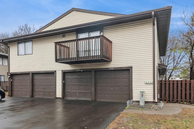 exterior space with a balcony and a garage