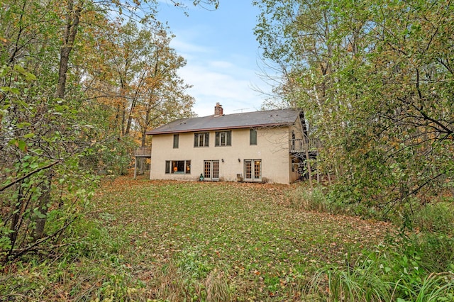 rear view of house with a lawn