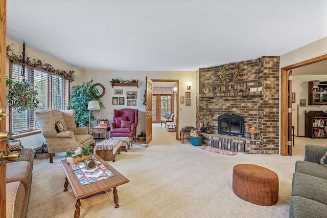 carpeted living room with a brick fireplace and a textured ceiling