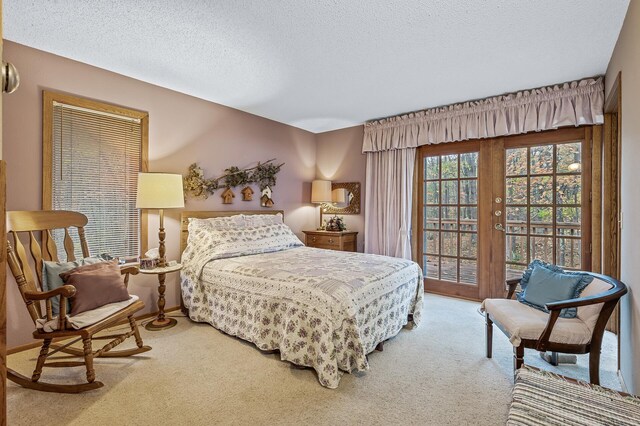 bedroom featuring a textured ceiling, carpet, french doors, and access to exterior