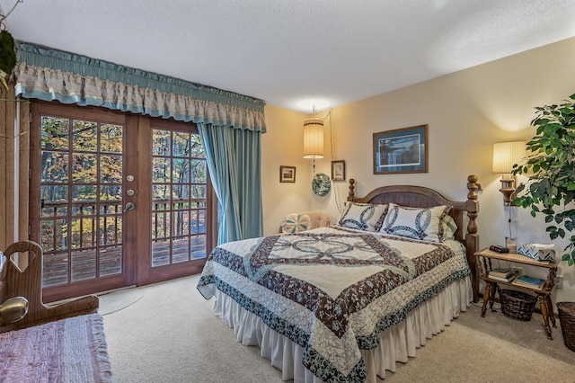 carpeted bedroom with a textured ceiling, french doors, and access to exterior