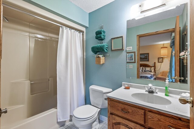 full bathroom with tile patterned flooring, a textured ceiling, vanity, shower / bath combo, and toilet