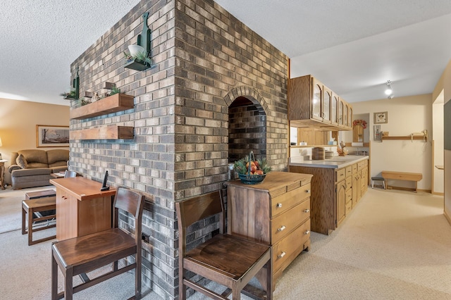 kitchen featuring a textured ceiling, butcher block counters, and light carpet